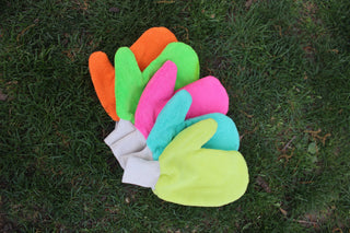 Colorful tick protection gloves on grass