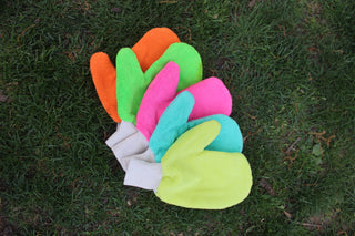 Colorful tick protection gloves on grass